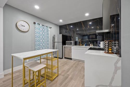 a kitchen with a counter and a clock on the wall at Modern Studio Retreat with Free Park in Houston