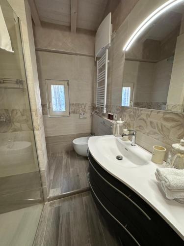 a bathroom with a sink and a shower at Casa vista lago la Rosella in Pieve Fosciana