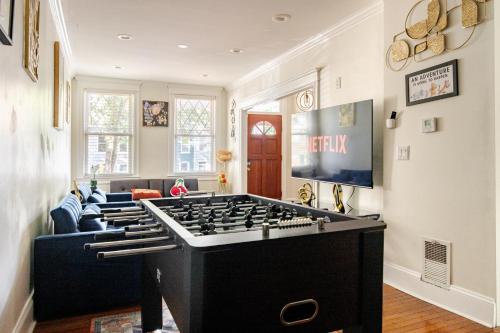 a living room with a large foosball table at Elegant 4BR & 4BA House in DC in Washington, D.C.