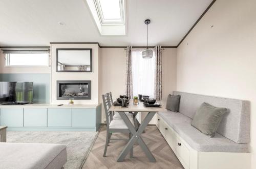 a living room with a table and a couch at Lodge 17 St Andrews in St. Andrews