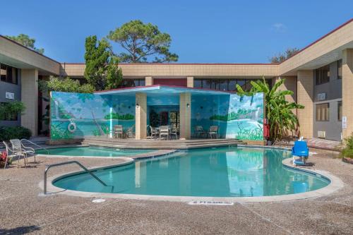 a swimming pool in front of a building at Red Roof Inn La Marque in La Marque