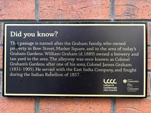 a plaque on the side of a brick building at The Colonel in Lisburn