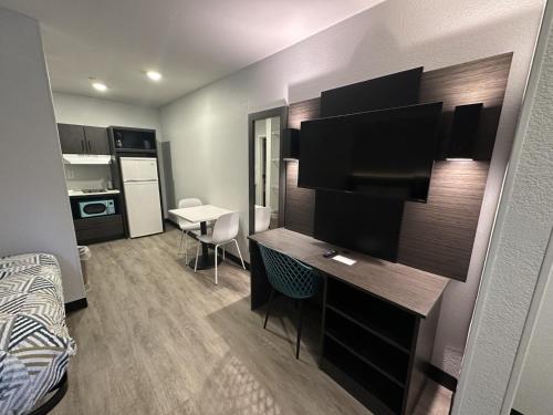 a small room with a desk and a room with a bed at Studio 6 Columbus GA Columbus Airport in Columbus