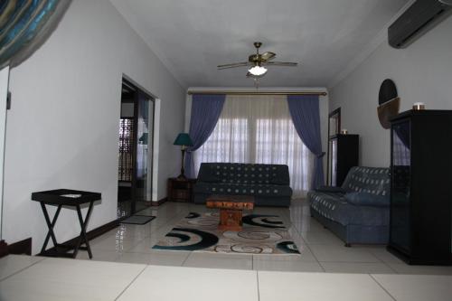 a living room with a couch and a table at Guest Home KS2E - Self Catering in Kempton Park