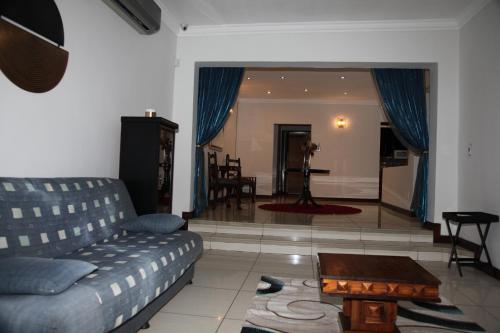 a living room with a couch and a table at Guest Home KS2E - Self Catering in Kempton Park