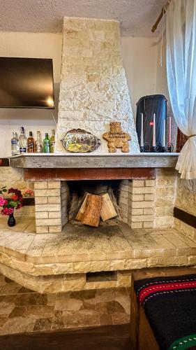 a stone fireplace with a plate of food on it at Родопска къща за гости с.ЧАЛА in Chala