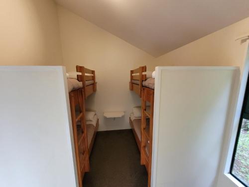 a bathroom with two bunk beds in a room at Waitomo TOP 10 Holiday Park in Waitomo Caves