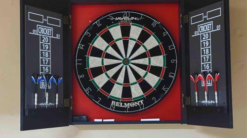 a dartboard with three darts on a wall at Retreat close to Lewisville Lake with pool, pet ok in Little Elm