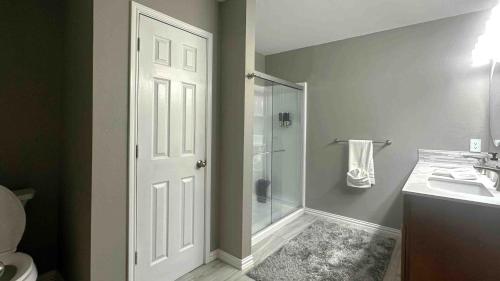 a bathroom with a shower and a toilet and a sink at Retreat close to Lewisville Lake with pool, pet ok in Little Elm