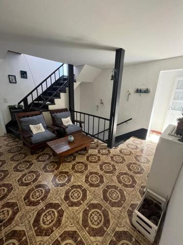 a living room with a couch and a staircase at Dptos7 Playas del sur in Mar del Plata