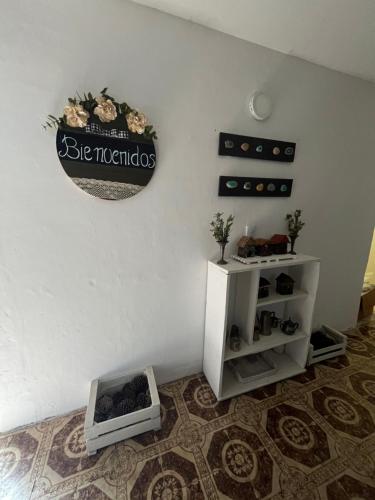 a room with a wall with a sign on the wall at Dptos7 Playas del sur in Mar del Plata