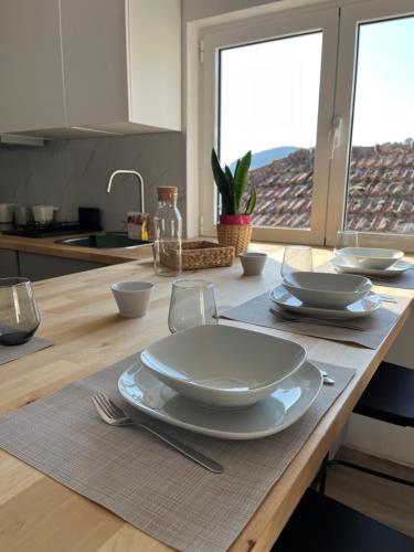 a kitchen with a table with plates and dishes on it at Villa Cerva Home in Cerva
