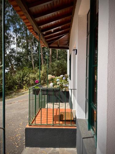 a balcony of a building with flowers on it at Habitación santo antonio in Estrela