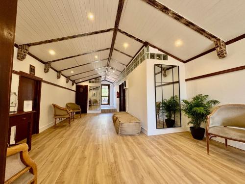 an empty room with a couch and chairs in a room at La Buhardilla del Refugio - Ideal for hikers, senderistas in Tejeda