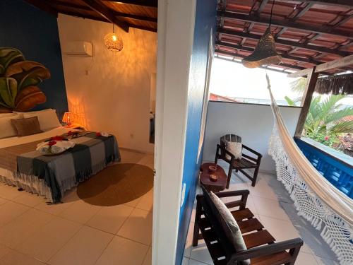 a bedroom with a bed and a balcony at Pousada Nascente do Sol in Ilha de Boipeba