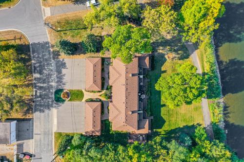 an overhead view of a house with a yard at Riverfront Champlin Townhome with Deck and Water View! in Champlin
