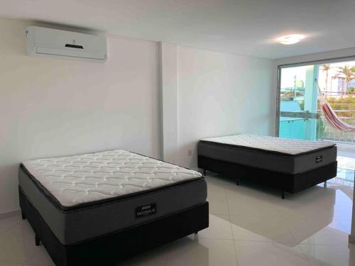 En eller flere senge i et værelse på Casa de Praia 3 Suítes c Ar condicionado e Piscina à 350m da Praia do Morro