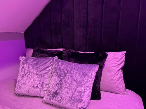 a purple bedroom with a bed with purple sheets and pillows at Toller Heights in Bradford