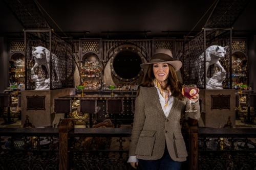 a woman in a hat holding a glass of wine at Caesars Republic Lake Tahoe in Stateline