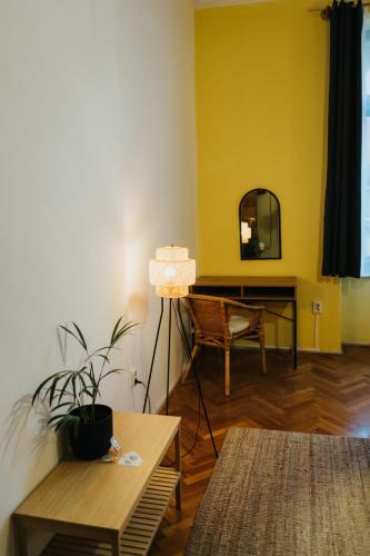 a living room with a table and a mirror at NAPartman Pécs in Pécs