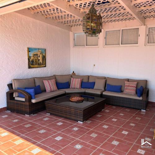 a living room with a couch and a table at La Maison Yacht in Cabo Negro