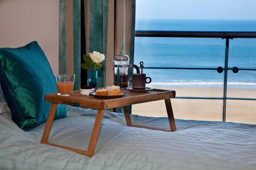 a table with a tray of food on a bed at The Sands Sea Front Apartments in Scarborough