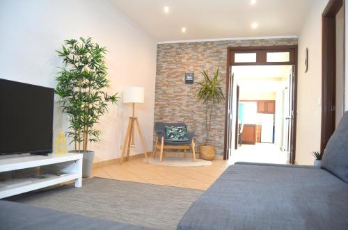 a bedroom with a bed and a tv in a room at House Fifteen in Horta