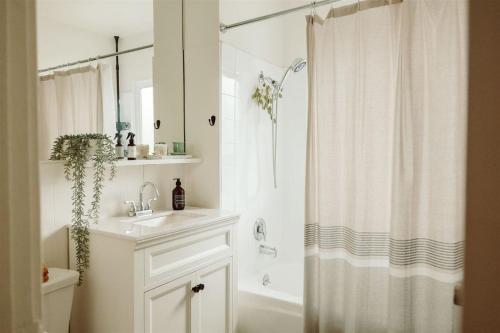 a bathroom with a sink and a shower curtain at Walk To Beach Restaurants - 5 Guests in Long Beach