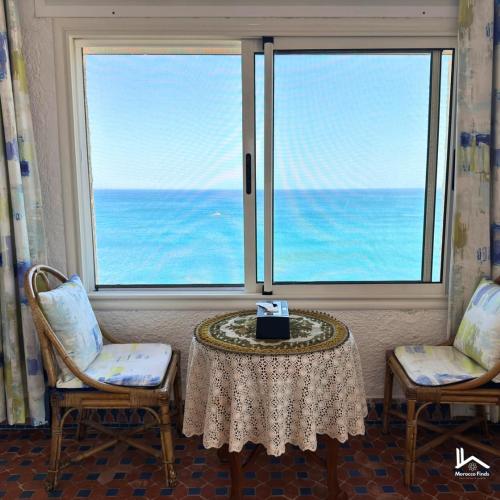 a room with a table and two chairs and a window at La Maison Yacht in Cabo Negro