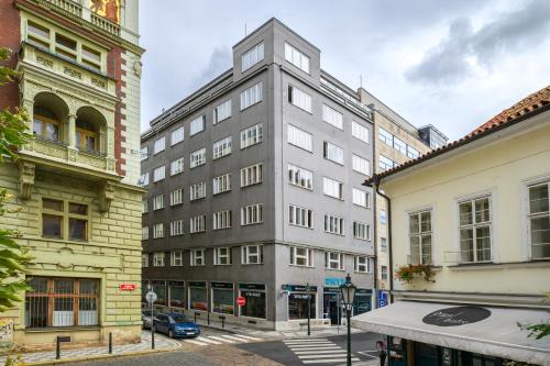 a tall gray building on a city street at Benedikt City Center Hostel in Prague