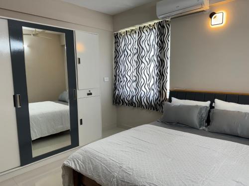 a bedroom with a large mirror and a bed at Aami dhivahi guest house in Trivandrum