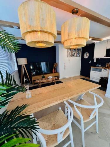 a dining room with a wooden table and chairs at Nautical living in Manly in Sydney