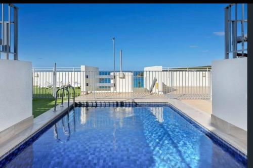 a large swimming pool in front of a building at Nautical living in Manly in Sydney