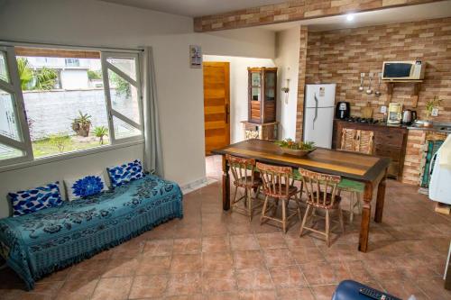 a kitchen and dining room with a table and chairs at Apartamentos exclusivos e equipado com varanda ou terraço com Pôr do sol, cozinha privativa, Wi-Fi 600MBs, a 700m da praia de Itapirubá e 1km da BR-101 in Imbituba
