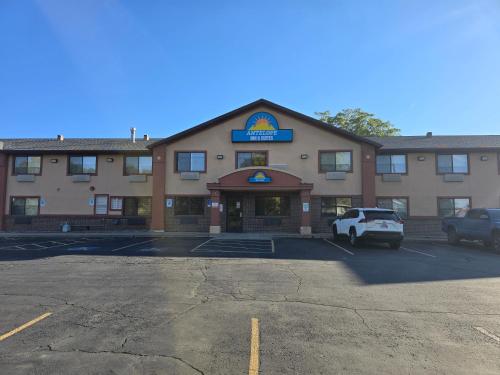 a hotel with a car parked in a parking lot at Antelope Inn & Suites in Clearfield