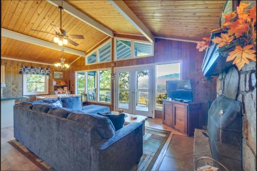a living room with a couch and a tv at Hot Tub and Mountain Views at Gatlinburg Cabin! in Gatlinburg