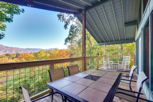 a screened in porch with a table and chairs at Hot Tub and Mountain Views at Gatlinburg Cabin! in Gatlinburg