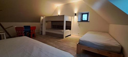 - une chambre mansardée avec 2 lits et une cheminée dans l'établissement Nouveau Maison campagne Plouescat - TyPra, à Plouescat