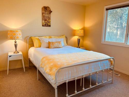 a bedroom with a bed and two lamps and a window at Sugar Shack in Downtown Meridian in Meridian