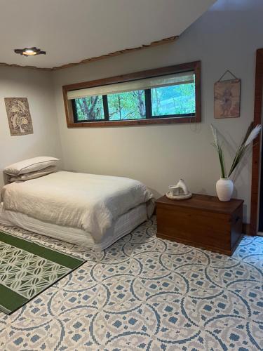 a bedroom with a bed and a window at Reefers in Kuaotunu