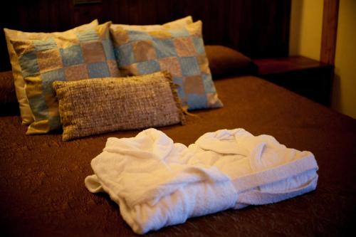 a pile of white towels on a bed with pillows at Mas del Bot in Valderrobres