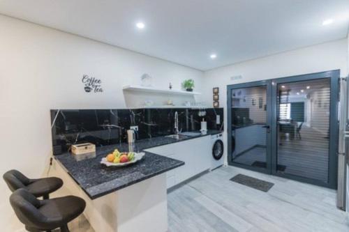 a kitchen with a bowl of fruit on a counter at Miramar in Ribeira Grande