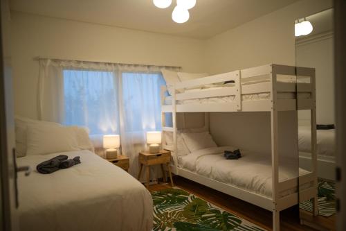 a bedroom with two bunk beds and a window at Sky Paradise 20min to zurich city centre in Widen