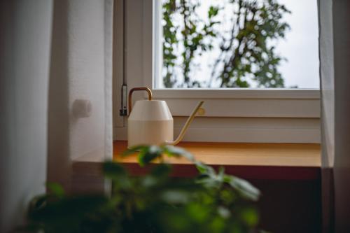 a lamp sitting on a table next to a window at Sky Paradise 20min to zurich city centre in Widen