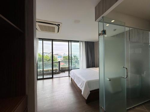 a bedroom with a bed and a glass shower at 22Land Moon West Lake in Hanoi