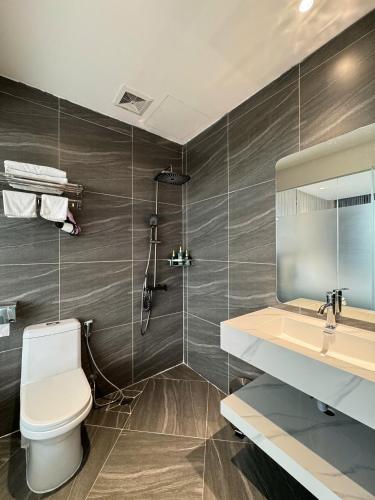 a bathroom with a toilet and a sink and a shower at 22Land Moon West Lake in Hanoi