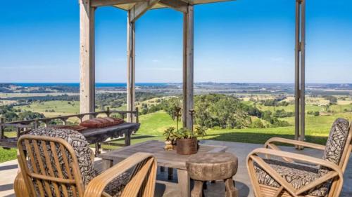 a porch with a table and chairs and a view at Hogans Bluff in Coopers Shoot