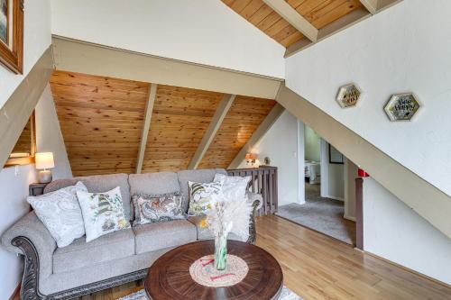 a living room with a couch and a table at Home with 2 Decks - 2 Mi to Lake Gregory Dog Park! in Crestline
