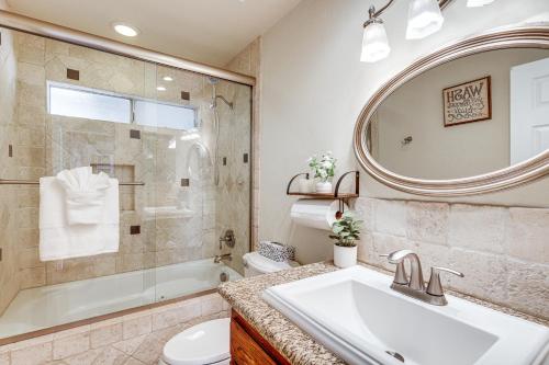 a bathroom with a sink and a toilet and a mirror at Home with 2 Decks - 2 Mi to Lake Gregory Dog Park! in Crestline