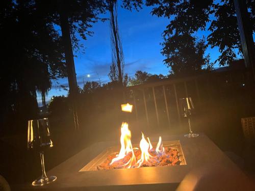 a fire pit in a backyard at night with two lights at Hikari-Okanagan Sunshine B&B in Kelowna